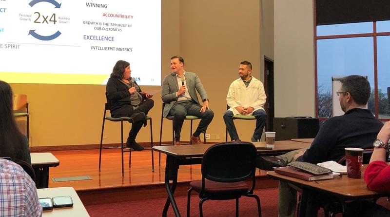 Alex participating in an employee panel discussion at FONA in 2019